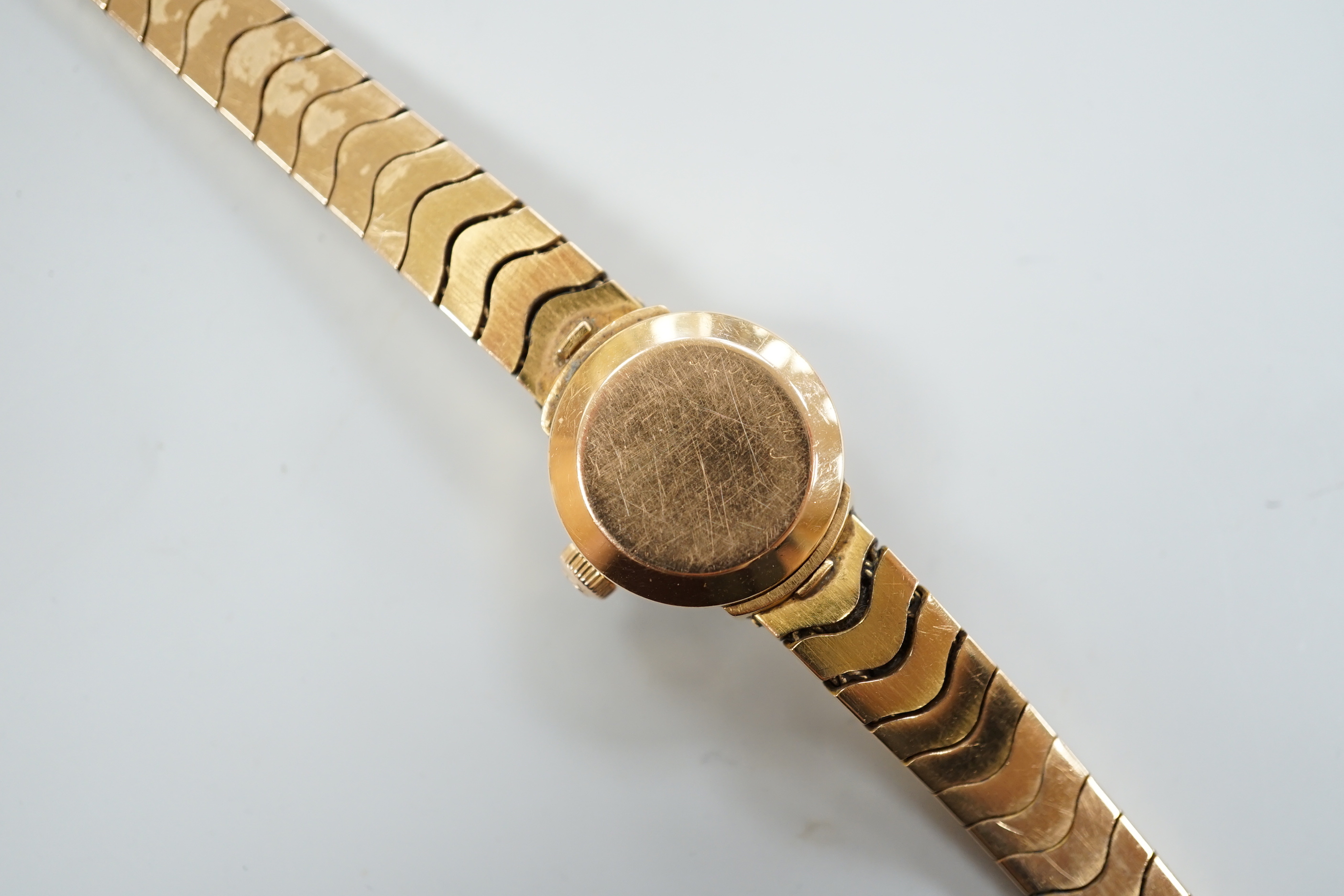 A lady's yellow metal, stamped 750, Omega Ladymatic wrist watch, on a 750 bracelet, length 17.cm, gross weight 38.9 grams.